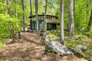 a house in the middle of the forest at Pocono Pines Penthouse with Private Deck! in Pocono Pines