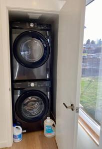 a washer and dryer in a room with a window at Modern two story townhouse near light rail in Seattle