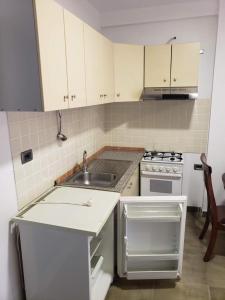 a small kitchen with a sink and a stove at Altiku Apartments in Golem