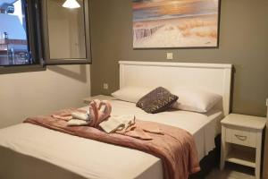 a bedroom with a bed with a towel on it at Pure Blue House in Athani