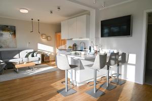 a kitchen and living room with a table and chairs at Helle Deel in Fehmarn
