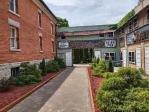 a building with a walkway between two buildings at The King George Inn in Cobourg