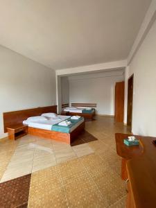 a large room with a bed and a table at Vila Senator 1 in Eforie Nord