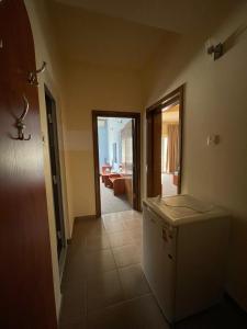 a kitchen with a refrigerator and a living room at Vila Senator 1 in Eforie Nord
