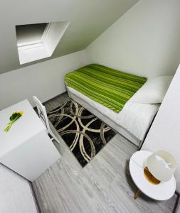 a small room with a bed and a table at The View Apartment Sarajevo in Sarajevo