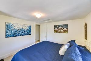 ein Schlafzimmer mit einem blauen Bett und zwei Gemälden in der Unterkunft Pet-Friendly Upstate NY Home Less Than 1 Mi to Cayuga Lake in Aurora