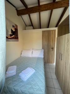 a bedroom with a bed with two towels on it at Vasiliki Little House in Kanoni