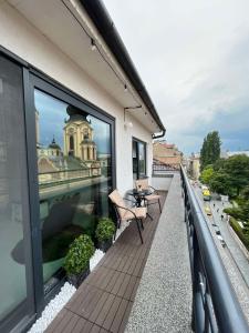 a balcony with a table and chairs on a building at Sarajevo Skyline Apartment in Sarajevo +45 photos