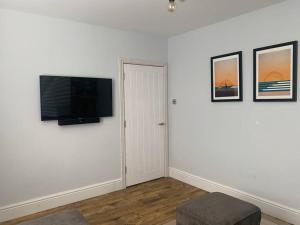 a living room with a flat screen tv on a wall at Braunton Breaks - South Break House in Braunton