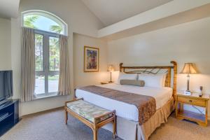 a bedroom with a bed and a large window at Palms at Wailea in Wailea