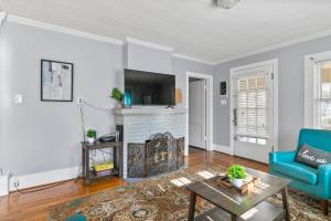 a living room with a fireplace and a blue couch at Beautiful Tarrant Home-Minutes to Airport and Downtown in Birmingham
