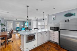 a kitchen with white appliances and a table and chairs at Beautiful Tarrant Home-Minutes to Airport and Downtown in Birmingham