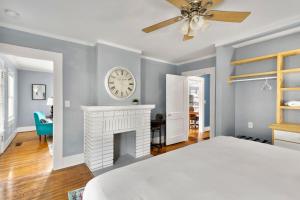 a bedroom with a fireplace and a clock on the wall at Beautiful Tarrant Home-Minutes to Airport and Downtown in Birmingham