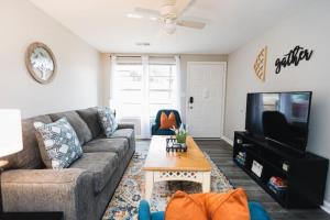 a living room with a couch and a tv at Forest Park Place in Birmingham