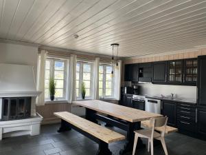 a kitchen with a wooden table and a bench at Tinden in Hemsedal