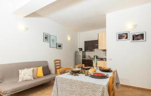 a living room with a table and a couch at La casa di NONNO ELIGIO in Bari Sardo