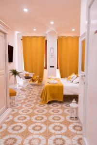 a room with a bed and a yellow curtain at Mausida Guest House in Lido di Ostia