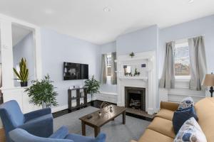 a living room with a couch and a fireplace at Near the Airport & Renovated East Lake Craftsman in Birmingham