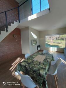 a room with a table and chairs and a staircase at DelViento Cabañas in Las Rabonas
