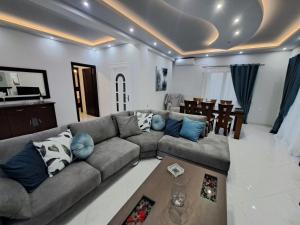 a living room with a couch and a table at Luxury apartment in Amarynthos