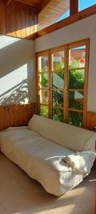 a large bed in a room with windows at Hotel Chagual in La Serena