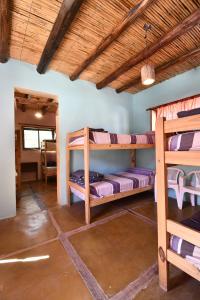 a room with bunk beds in a house at Tilcara Rustica Hostel in Tilcara
