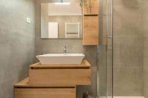 a bathroom with a sink and a mirror at ABI Attic Apartment in Šibenik +38 photos