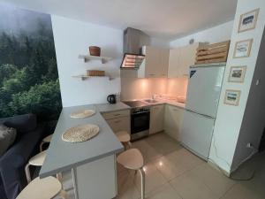 a small kitchen with a table and a refrigerator at Kasprusie 10 by Homeprime in Zakopane