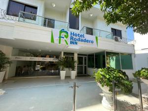 a hotel rotario inn with plants in front of it at Hotel Rodadero Inn By GEH Suites in Santa Marta +33 photos