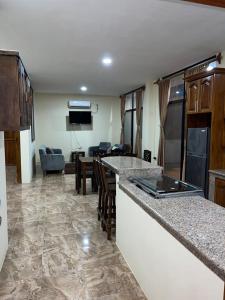 a kitchen with a bar and a living room at Departamento vista al mar en Puerto López in Puerto López