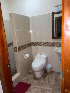 a bathroom with a toilet and a sink at Departamento vista al mar en Puerto López in Puerto López