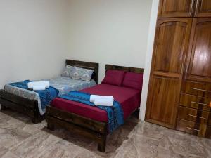 a bedroom with a bed and a couch next to a cabinet at Departamento vista al mar en Puerto López in Puerto López
