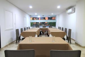 a row of tables and chairs in a room at Hotel Rodadero Inn By GEH Suites in Santa Marta