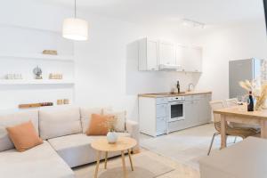 a living room with a couch and a table at Propela apartments in Božava