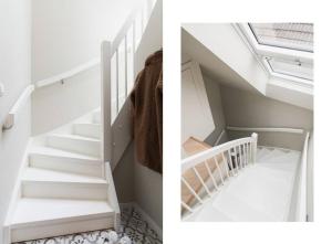 a staircase in a house with white walls at Dinbnb Apartments I Mid-City Luxury with Mini Balcony and Smart TV & Sound System in Bergen