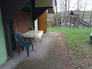 a table and chairs sitting on a brick patio at Zalesie z pomostem I in Barczewo