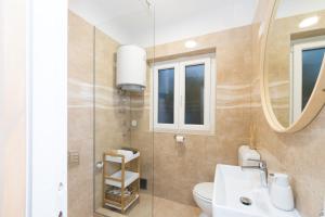 a bathroom with a sink and a toilet and a mirror at Propela apartments in Božava +38 photos