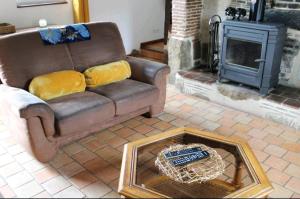 a living room with a couch and a fireplace at Gite écurie familly in Familly