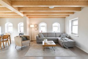 a living room with a couch and a table at Kleene Slott in Fehmarn