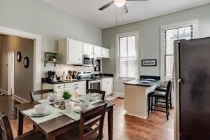 a kitchen and dining room with a table and chairs at Mins from Downtown & Dining, Dauphin Darling 2 in Mobile