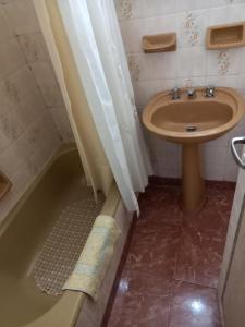 a bathroom with a sink and a toilet and a tub at DESCANSO IDEAL III Casino, playa y shopping in Mar del Plata +14 photos