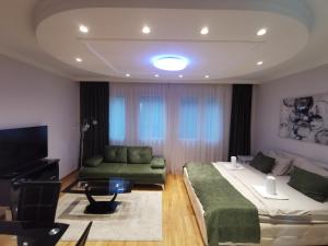 a living room with two beds and a couch at Fortuna Lux in Zvezdara