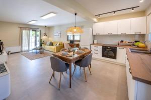 a kitchen and living room with a table and chairs at Mi Casa Su Casa in Kos