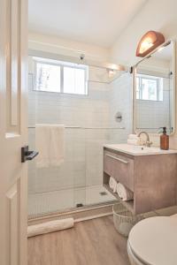 a bathroom with a shower and a sink and a toilet at Aloha Fridays in Miami Beach