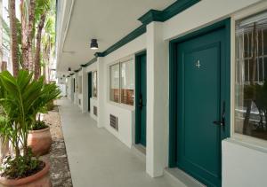 a hallway with a blue door on a building at Aloha Fridays in Miami Beach