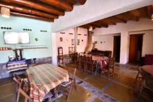 a room with a table and chairs in it at Tilcara Rustica Hostel in Tilcara