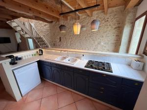 a kitchen with a sink and a stove at No 10 Vic Fezensac in Vic-Fezensac