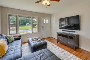a living room with a couch and a flat screen tv at Greensboro Vacation Rental 2 Mi to Downtown! in Greensboro