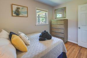 a bedroom with a bed with a backpack on it at Greensboro Vacation Rental 2 Mi to Downtown! in Greensboro