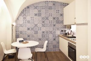 a small kitchen with a table and chairs at Vico37 Apartment in Acireale